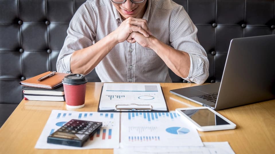 Man looking at graphs on a table