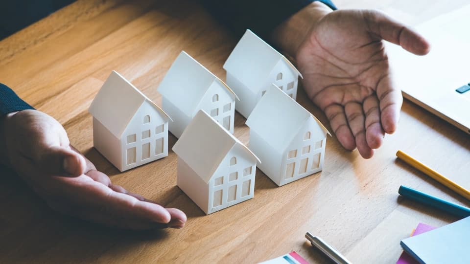 Business property, real estate and investment concepts with investor and white model house
