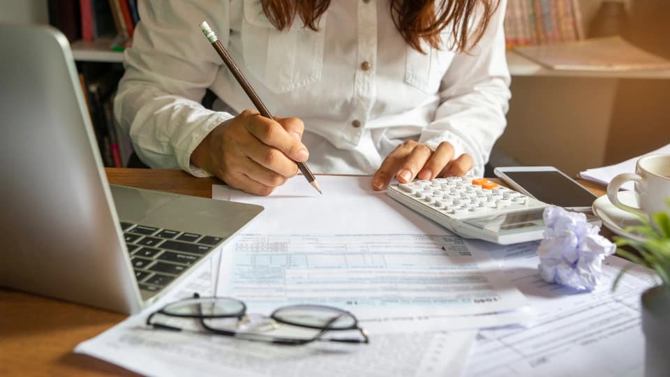 Person at a table doing a budget